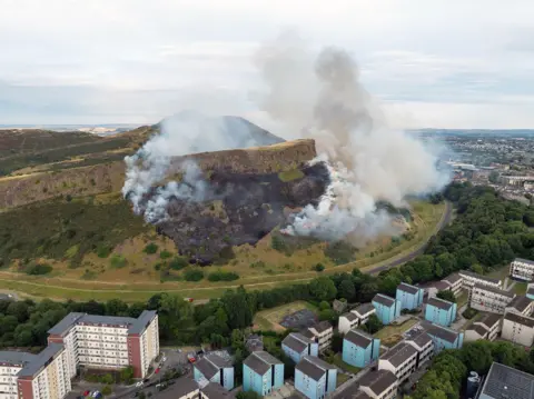 Craig Duncan Photography An aerial shot of white plumes of smoke coming from Arthur's Seat. 
