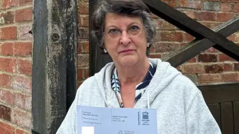 Catherine Bearder outside home with European Flag