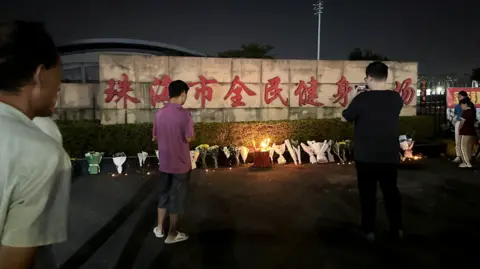 Reuters Mourners paying tribute to the victims outside the Zhuhei Sports Centre on Tuesday 12/11/24.