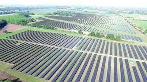Boom Energy Artist impression of the solar farm to be built near Howden. It shows rows of panels in fields surrounded by trees.