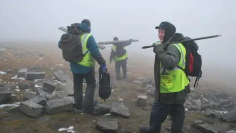 The stonemasons making their way back down Slieve Donard
