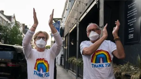 EPA Members of the public applaud during the "Clap For Our Carers" campaign