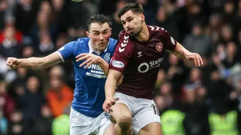 Hearts' Claudio Braga (R) and Rangers' John Souttar in action during a William Hill Premiership match between Rangers and Heart of Midlothian at Ibrox Stadium
