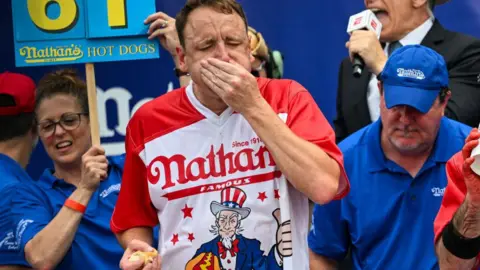 Getty Images Joey seen stuffing his face with hot dogs at the 2023 Nathan's contest