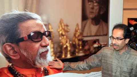 Getty Images Shiv Sena President Uddhav Thackeray showing portrait of his father late Bala Saheb Thackeray during the inauguration his infrared photography exhibition at Jehangir Art Gallery on January 6, 2015 Mumbai, India.