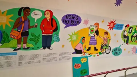 JASON WHITE/BARNSLEY CIVIC Another section of the mural, featuring cartoon depictions of children talking.