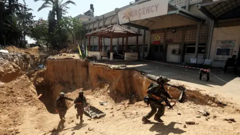 Reuters Israeli soldiers emerge from a tunnel beneath the compound of the European Hospital in Khan Younis, southern Gaza (8 June 2025)