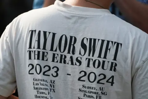 Reuters A Taylor Swift fan waits outside Madison Square Garden, ahead of a reported wedding between singer Taylor Swift and National Football League (NFL) player Travis Kelce, in New York City, U.S., July 2, 2026.
