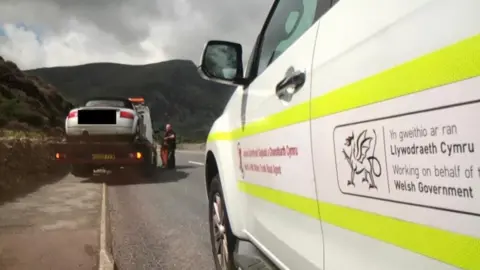 North Wales Police Car on the back of a tow truck