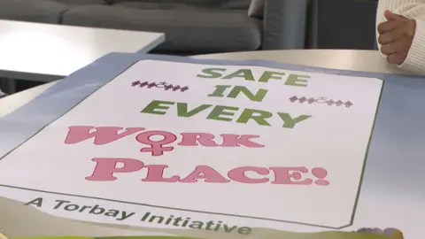 A poster saying Safe in every workplace, a Torbay initiative