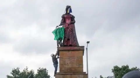 NurPhoto Misak indigenous stand in front of police officers as she protest next to the statue of queen Isabel of Spain on June 09, 2021 in Bogota, Colombia.