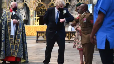 PA Media Boris Johnson greets Sgt Sebastian Mwaura from the Defence Medical Group at Westminster Abbey's annual service for the Florence Nightingale Foundation