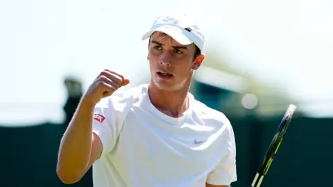 PA Media Oliver Tarvet celebrates during his match against Leandro Riedi on day one of the 2025 Wimbledon Championships at the All England Lawn Tennis and Croquet Club, London