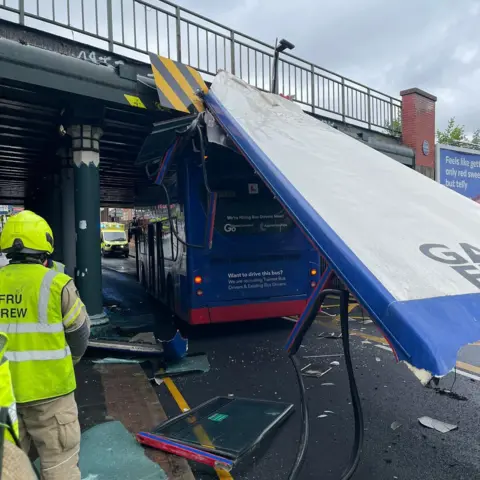 Network Rail Bus with roof ripped off and men wearing hi-vis vests