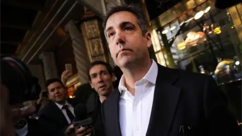 Getty Images Michael Cohen leaving his apartment on Monday to serve his sentence