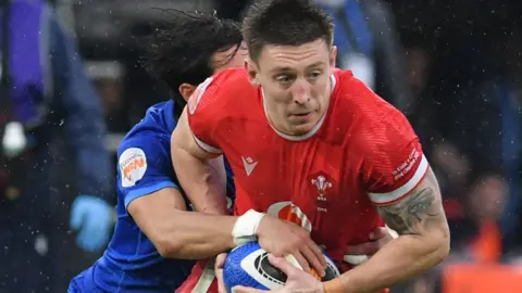 Wales' Josh Adams tries to escape a tackle against Italy