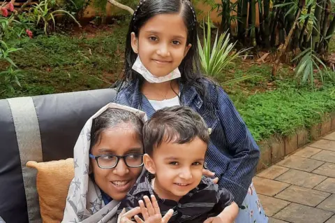 Afra Rafeeq/YouTube Afra with her brother Muhammed and sister Anzila