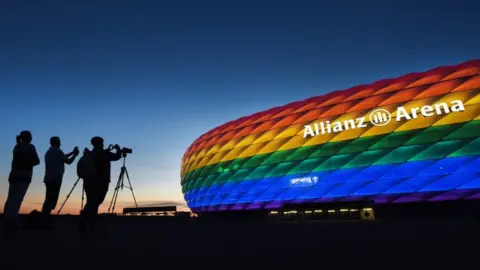 EPA The facade of the landmark "Allianz Arena" stadium is illuminated in the rainbow colours of the LGBT (Lesbian, Gay, Bisexual and Transgender) movement to mark the Christopher Street Day, in Munich, Germany, 09 July 2016