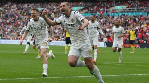 Michael Cheek celebrates scoring for Bromley in the National League promotion final against Solihull Moors at Wembley