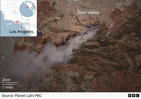 A satellite image showing smoke rising from a fire south of Simi Valley