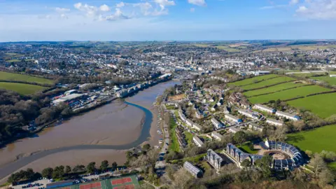 Cornwall Council A image taken from above of part of Truro. Including in the picture is a long stretch of river, numerous buildings and the centre of Truro in the distance.