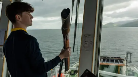 Getty Images The baton being taken from Claonaig to Lochranza on Arran by ferry