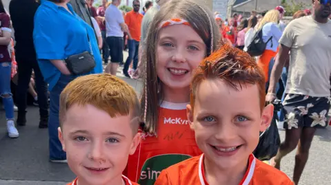 Three children wearing their Armagh tops