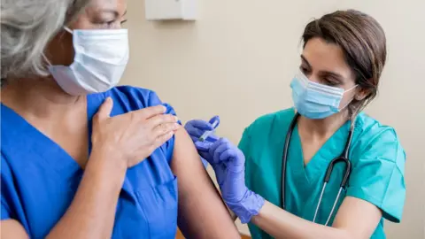 Getty Images Vaccinating a healthcare worker