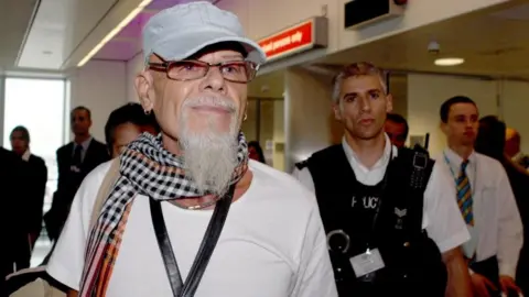 PA Media Gary Glitter arriving at Heathrow Airport in August 2008