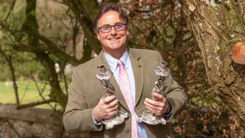 Moore Photographics Gordon holds candlesticks