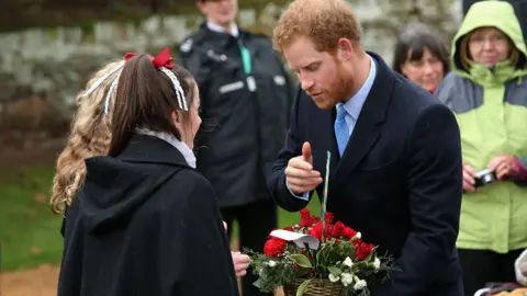 Getty Images Prince Harry receiving flowers on a church visit on Christmas Day in 2015