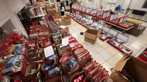 BVS There are rows of hampers and christmas bags full of food on the temple floor