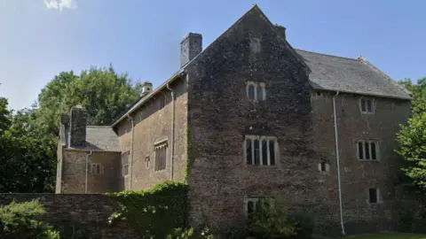 A large building surrounded by trees.