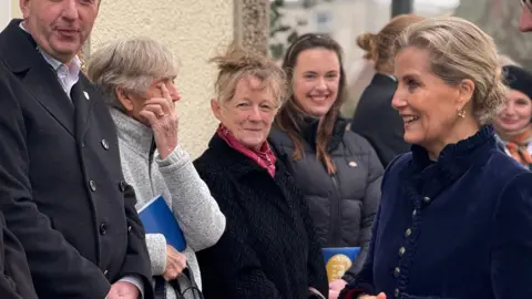 The Duchess of Edinburgh speaks to people who have lined up to see her during a royal visit in Alderney.