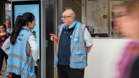 Phil Coomes Jeffery chats with a colleague on the platform