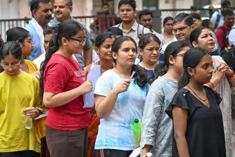 Hindustan Times via Getty Image Students arrive at an examination centre to appear for the National Eligibility-cum-Entrance Test (NEET-UG) in Delhi