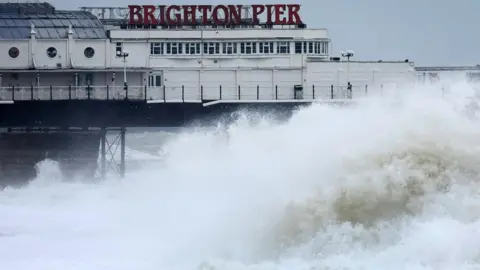 ANDY RAIN/EPA-EFE/REX/Shutterstock Huge waves crash onto the beach near Brighton pier.