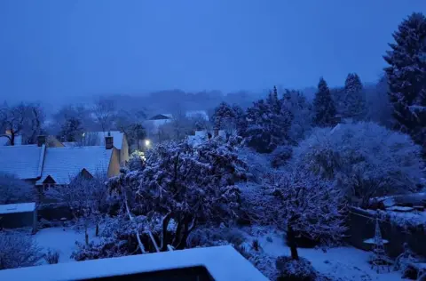 The village of Blockley in Gloucestershire is seen in the early morning light with a covering of snow on houses and trees