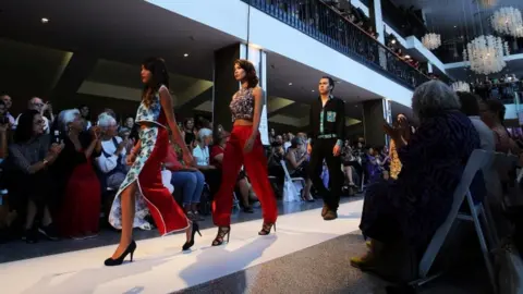 Reuters Spectators watch as models walk down the runway during the inaugural Vancouver Indigenous Fashion Week in Vancouver, British Columbia, Canada July 27, 2017.