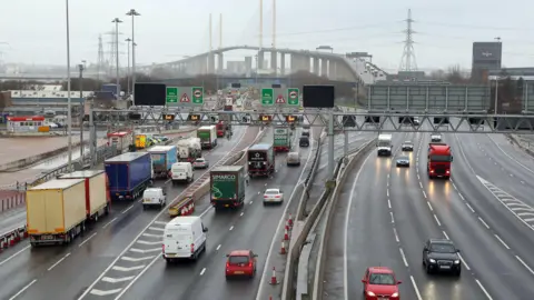 PA Media Lorries and cars driving on the Dartford Crossing which connects Essex to Kent