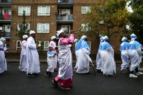 Simon Dawson / Reuters Members of the Eternal Sacred Order of Cherubim and Seraphim Church parade