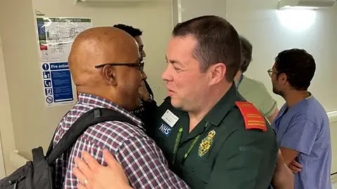 LAS Atul's dad Ajay hugs paramedic Nick Sillett who was the person who told him his son had collapsed