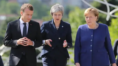 Reuters Emmanuel Macron, Theresa May and Angela Merkel