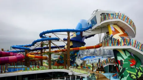 Getty Images Workers place lounge chairs next to the Royal Bay pool onboard the Royal Caribbean Icon of the Seas cruise ship at Port Miami in Miami, Florida, US, on Thursday, Jan. 11, 2024.