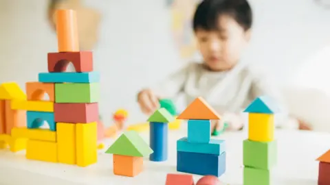 Getty Images A boy playing with blocks