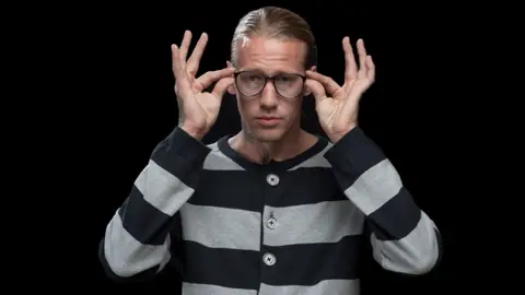 Papillion A model wearing a Papillon cardigan