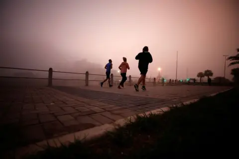 Reuters Joggers in the mist
