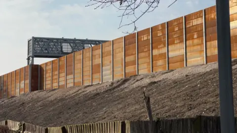 Sean Woodward Rusty metal wall next to the M27