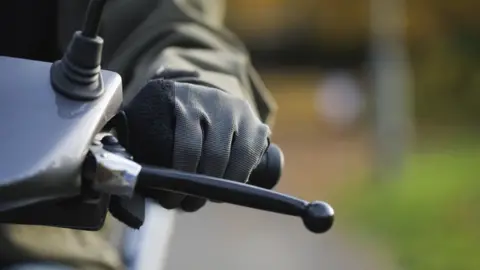 Getty Images Close up of motorbike handlebars