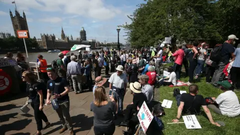 PA Media Protesters gathered on Albert Embankment in London before heading to Parliament